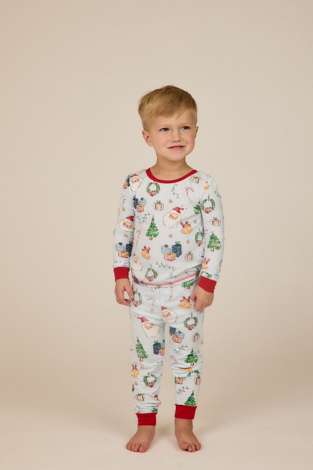 Light blue bamboo Little Kids Christmas pajamas with Santa, tree, and gift print and red ribbed trim. Available in little kids sizes.