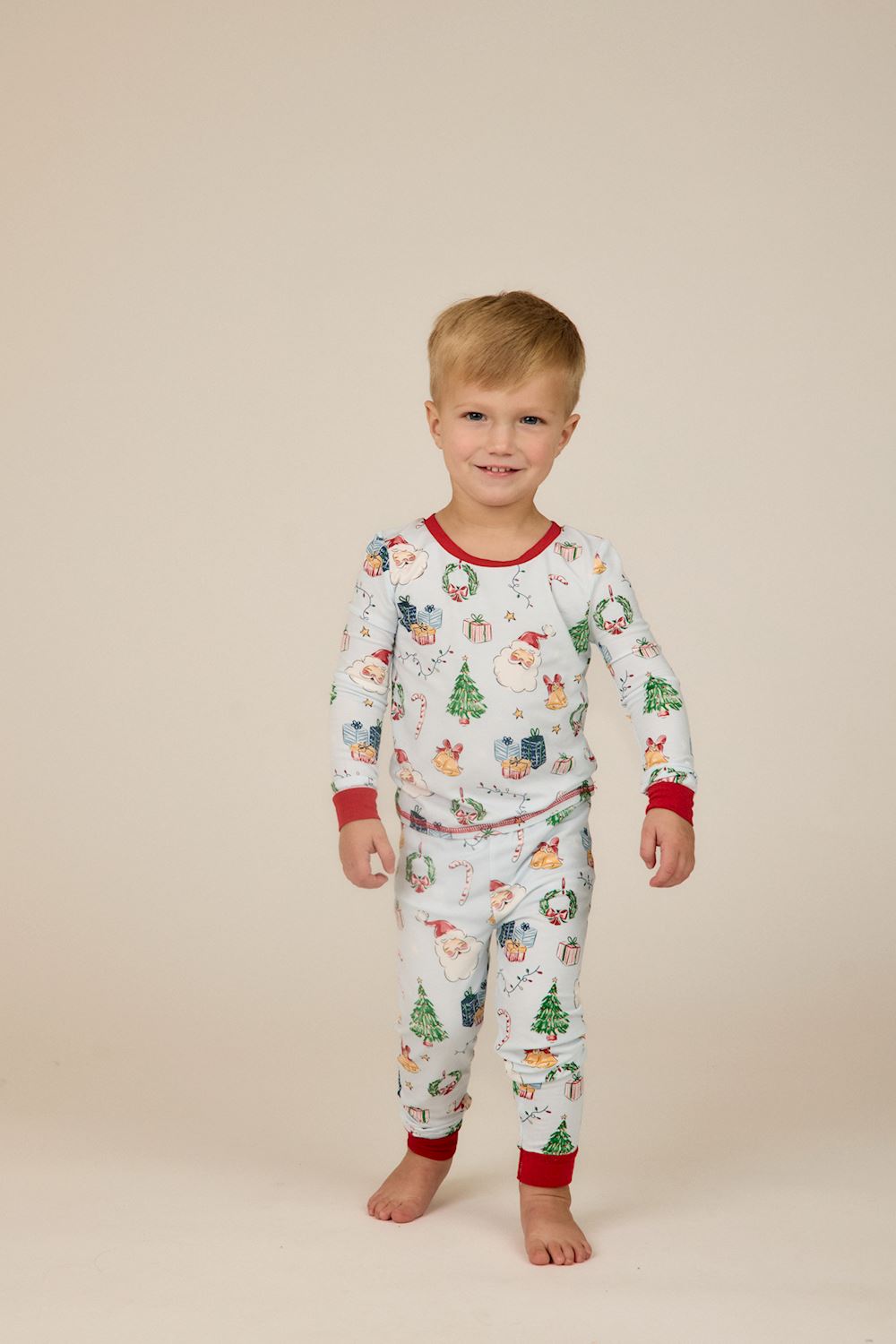 Little Kids Blue Christmas Print PJs, long-sleeve bamboo set with light blue holiday print and red trim.