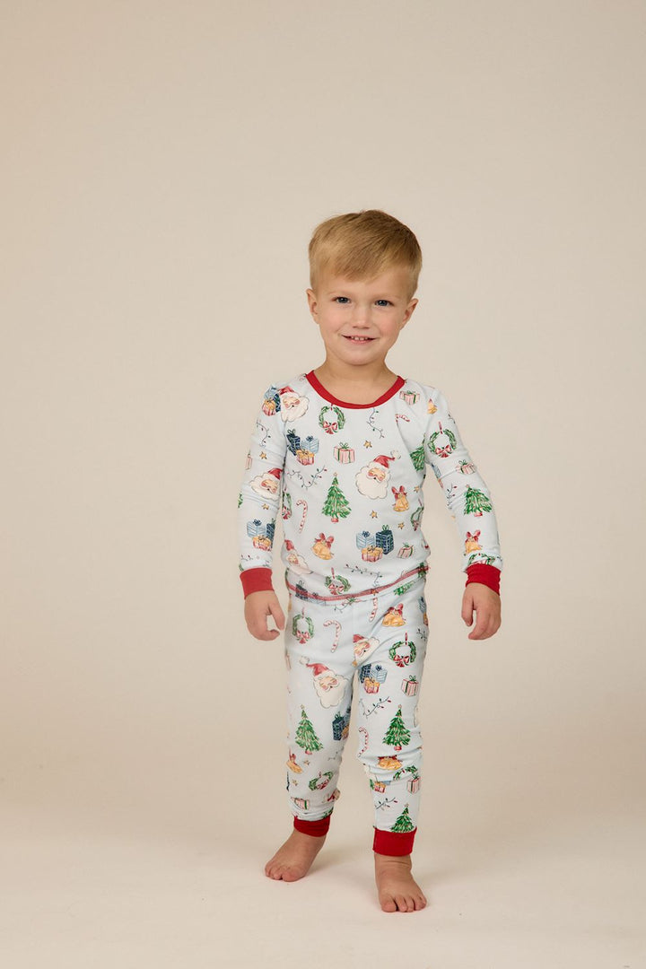 Little Kids Blue Christmas Print PJs, long-sleeve bamboo set with light blue holiday print and red trim.