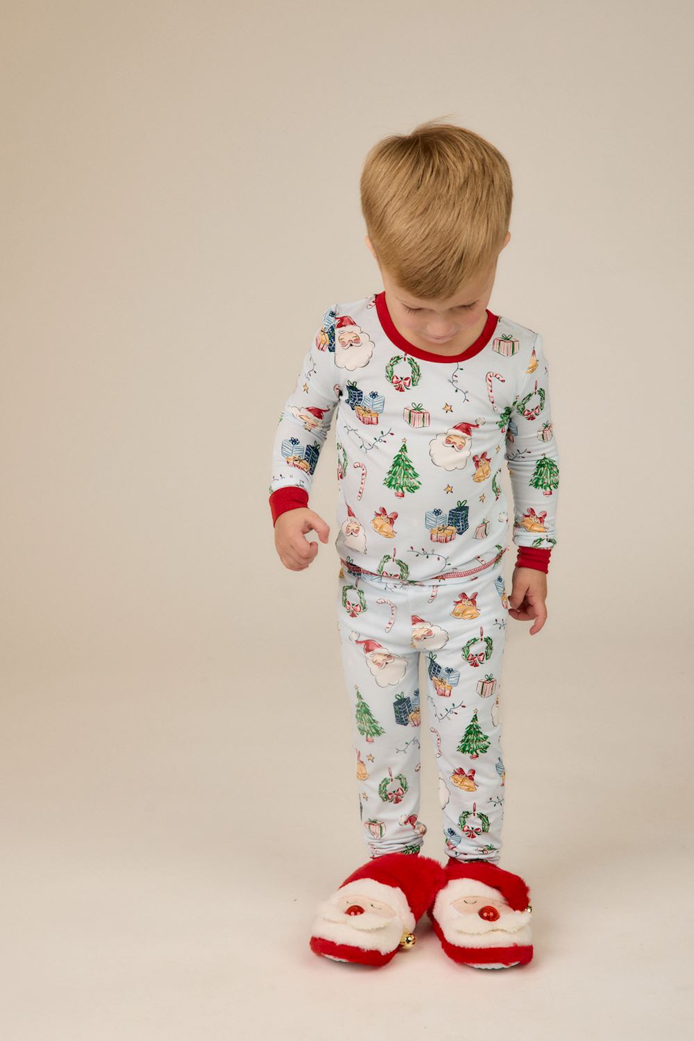 Little Kids Blue Christmas Print PJs in light blue bamboo with Santa, tree, and gift print, featuring red trim. Available in little kid sizes.