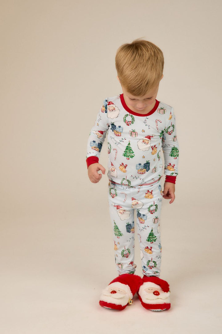 Little Kids Blue Christmas Print PJs in light blue bamboo with Santa, tree, and gift print, featuring red trim. Available in little kid sizes.