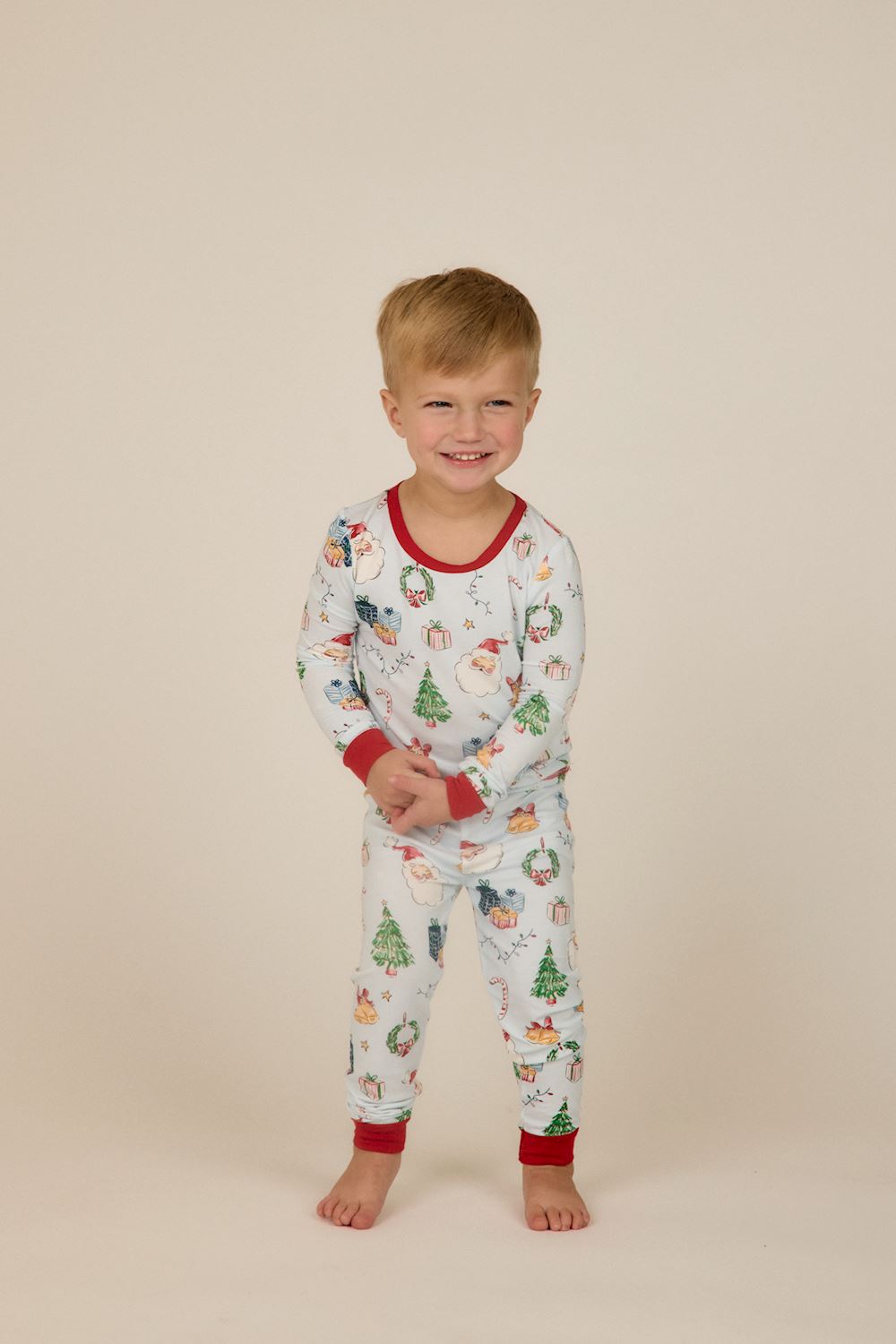 Little Kids Blue Christmas Print PJs: light blue long-sleeve bamboo pajama set with Santa, tree, and gift print and red ribbed trim. Available in Little Kids sizes.