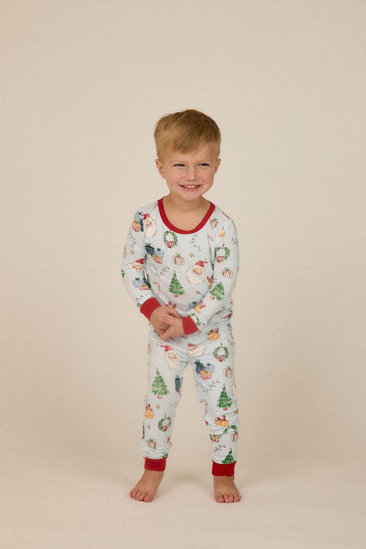 Little Kids Blue Christmas Print PJs: light blue long-sleeve bamboo pajama set with Santa, tree, and gift print and red ribbed trim. Available in Little Kids sizes.