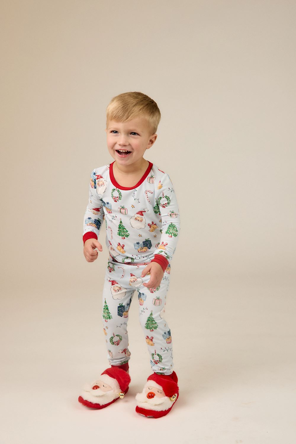 Little Kids Blue Christmas print bamboo pajama set with Santa, tree, and gift pattern and red trim. Available in little kids sizes.