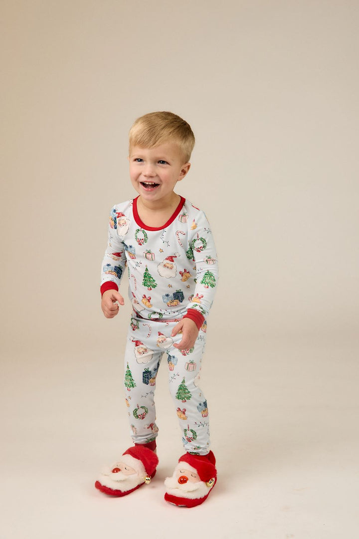 Little Kids Blue Christmas print bamboo pajama set with Santa, tree, and gift pattern and red trim. Available in little kids sizes.