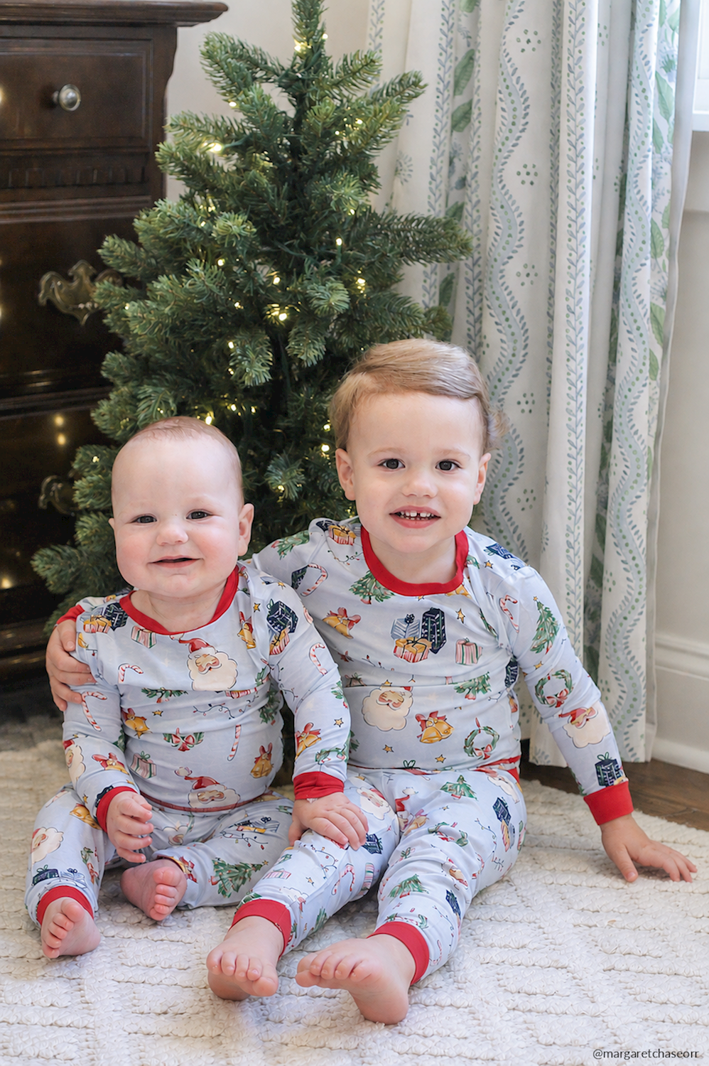 Little Kids Blue Christmas Print PJs in light blue bamboo with Santa, present, and wreath print, red trim, and available in little kids’ sizes.