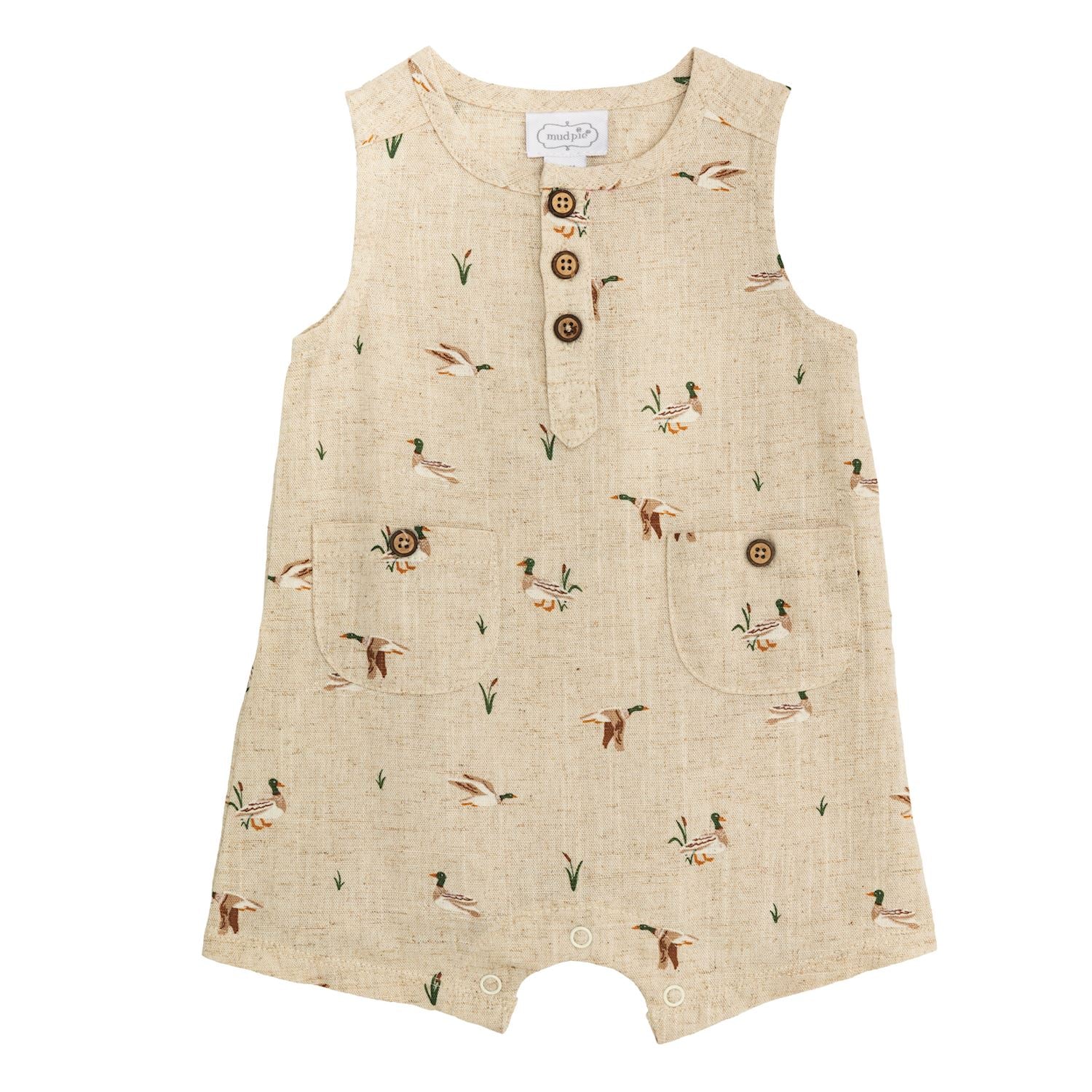 Beige linen infant shortall with duck and plant print, front pockets, coconut buttons. Sizes available: newborn to 24 months.