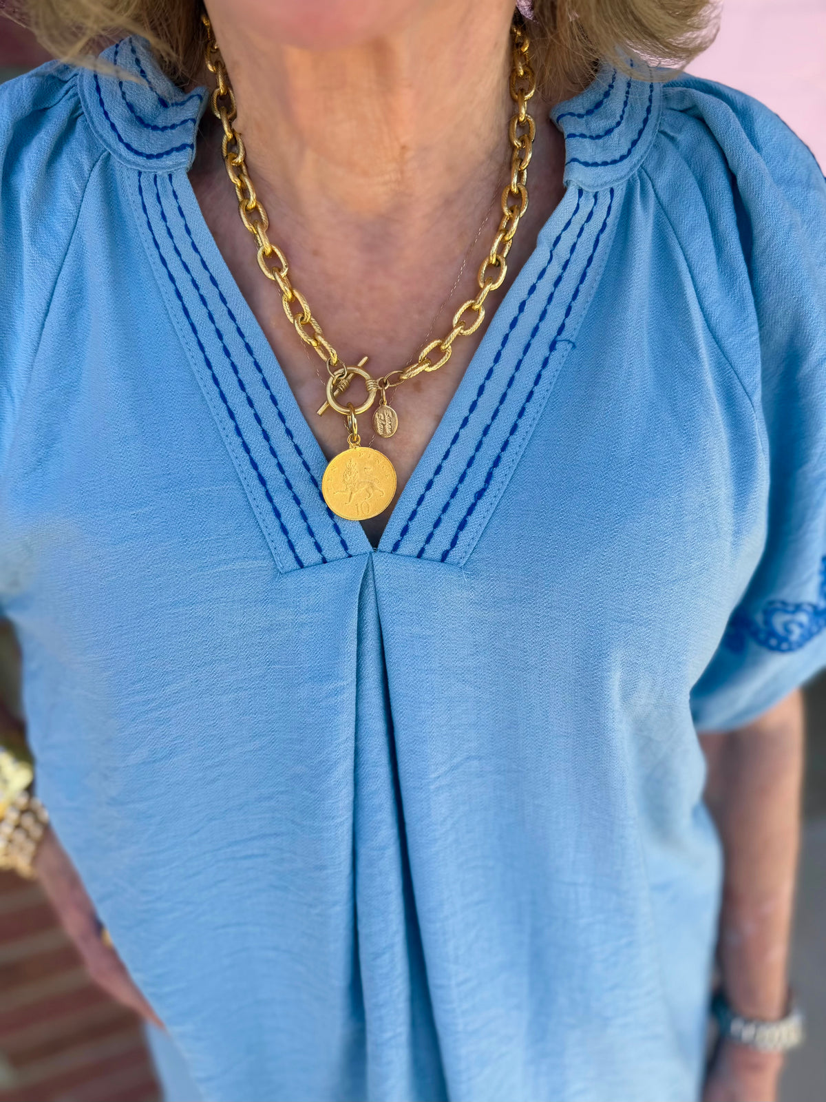 Light Blue Embroidered Puff Sleeve Top with dark blue stitching, available in sizes XS-XL.