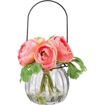 **Pink Ranunculus Vase**

- Material: Clear glass with black metal handle
- Design: Round, ribbed vase
- Contents: Pink ranunculus bouquet with green leaves
- Flowers: Full bloom, vibrant petals
- Sizes available: Small