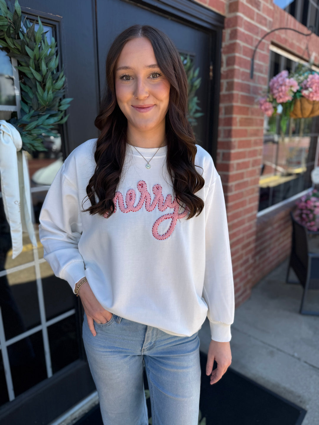 White Sarah Merry Boucle Sweatshirt with pink embroidered “merry” text. Available in all sizes.