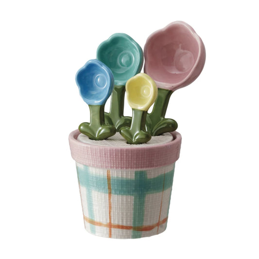 Hand-painted stoneware measuring spoons, flower-shaped, with pastel plaid pot holder. Sizes: 1 Tbsp, 1 tsp, 1/2 tsp, 1/4 tsp.