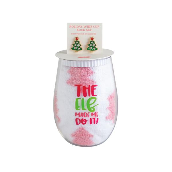Holiday wine glass, earring, and sock set including a stemless glass, white socks with “THE ELF MADE ME DO IT!” text, and Christmas tree earrings.
