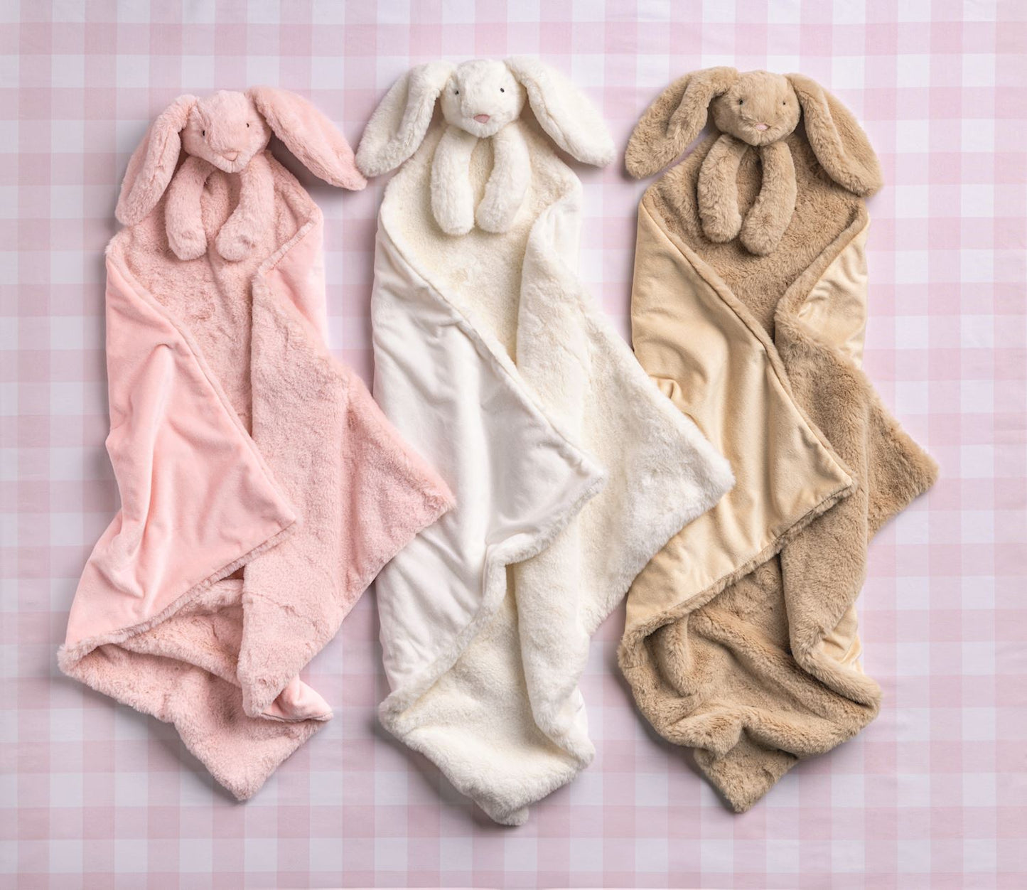 Cuddle Plush Blankets in pink, white, and beige with matching bunny plush. Available in S, M, L. Soft faux fur with bunny head.