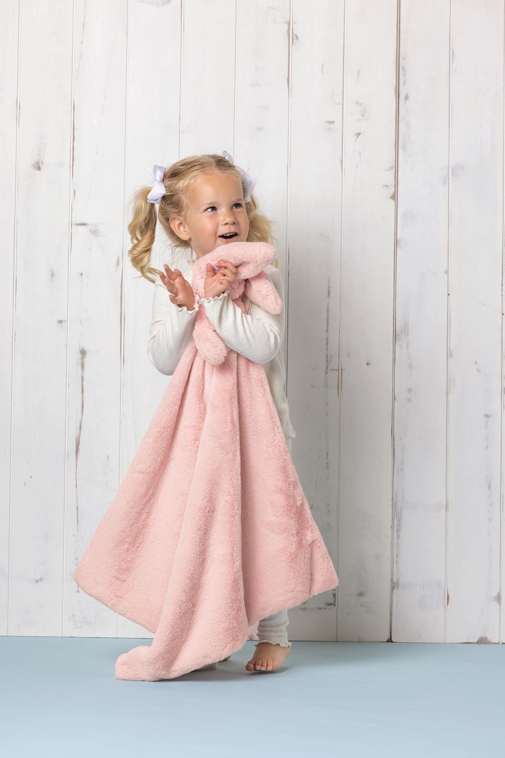 Large pink Cuddle Plush Blanket, ultra-soft. Available in sizes: small, medium, and large.