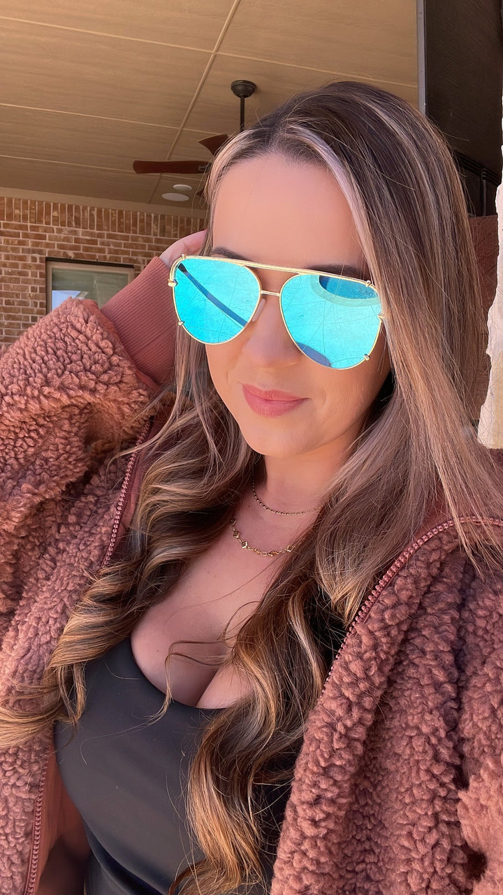 Dax Shay Sunglasses with blue reflective lenses, UV 400 protection. Available in small, medium, and large sizes.
