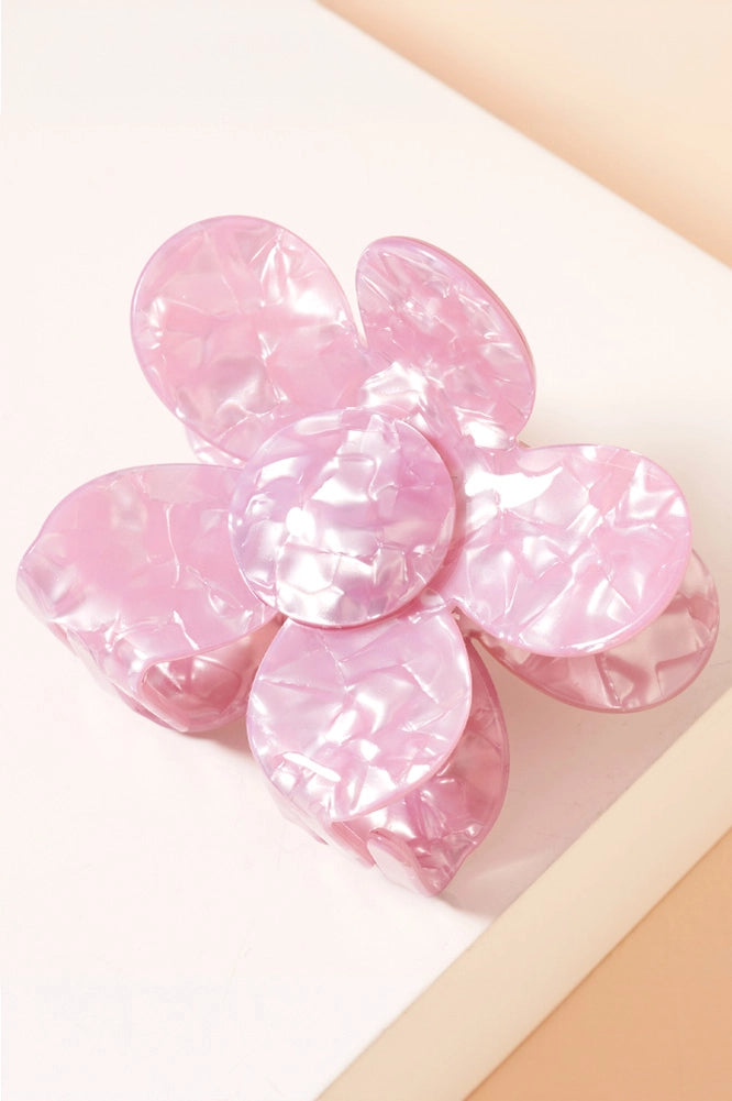 Pink marbled Daisy Pearlized Hair Clip, flower-shaped with layered petals and a glossy, translucent finish. Sizes available: Small, Medium, Large.