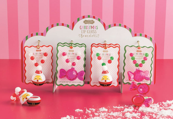 Four Christmas lip gloss bracelets in four styles, featuring two Santa charms and two candy charms.