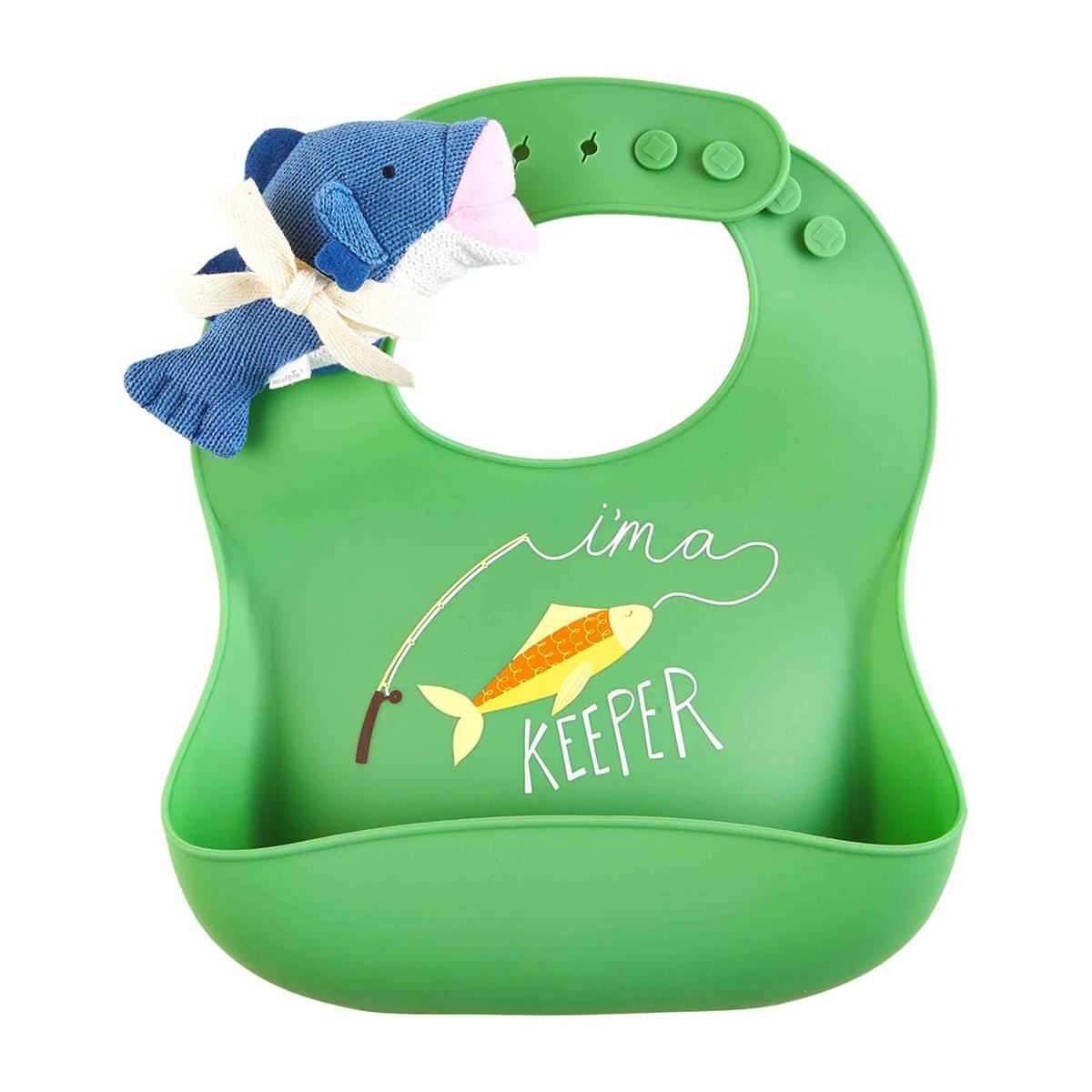 A Fish Bib & Rattle Set with a pocket at the bottom, featuring a design of a fish on a hook and the phrase "i'm a keeper." A blue and white striped cloth fish toy is attached