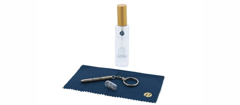 The Peepers - Cleaning Kit includes a gold-capped bottle, navy blue microfiber cloth, keychain tool, and small clear case. Sizes available.