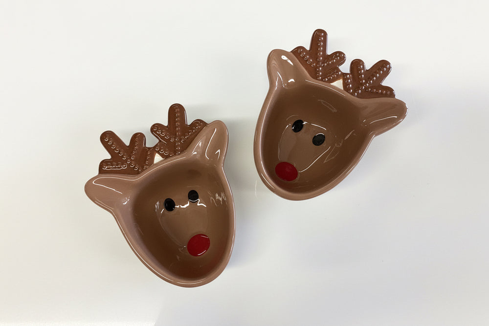 Two brown reindeer-shaped tidbit bowls with red noses and spotted antlers.