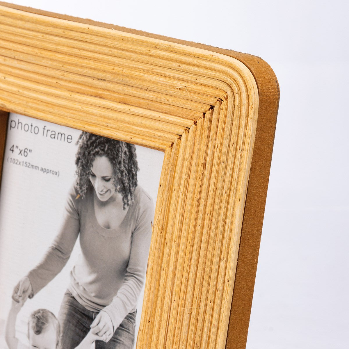 Rattan Photo Frame with layered texture, holding a black and white photo. Available sizes: 4"x6", 5"x7", 8"x10".