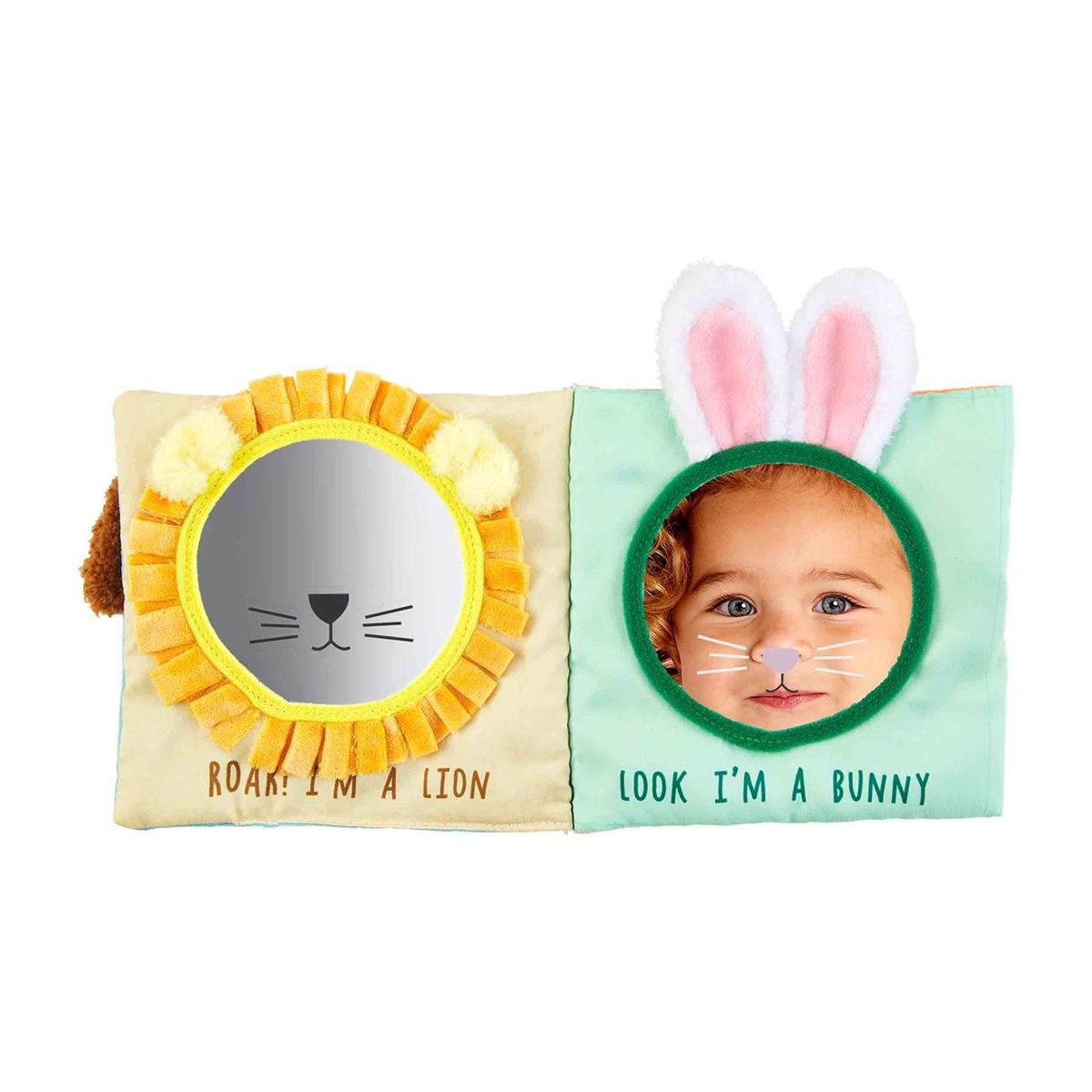 Inside of baby book. Shows yellow page on left with lion face, felt mane, and plush ears surrounding a mirror. On right side is green page with bunny ears and nose on mirror with a baby in the mirror. Lion side says "Roar! I'm a lion" and Bunny side says "Look I'm a Bunny"