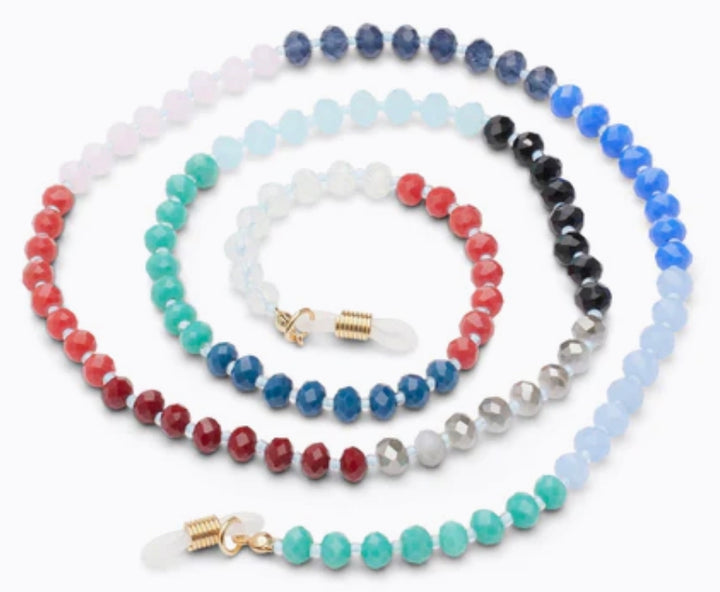 The Peepers Beaded Chain necklace is adorned with concentric loops of faceted beads in blue, red, green, and white colors. It has golden clasps and clear attachments. Available sizes: 18", 20", 22".