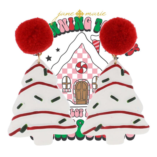 The Red Pom with Christmas Tree Cake Dangle Earrings feature white Christmas trees with red stripes, green dots, and lively red pom-poms. Size: One size fits all.