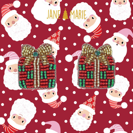 The "Red and Green Checkered with Gold Bow Beaded Present Earrings" are festive earrings shaped like gifts, featuring green, red, and gold accents. Sizes: One size.