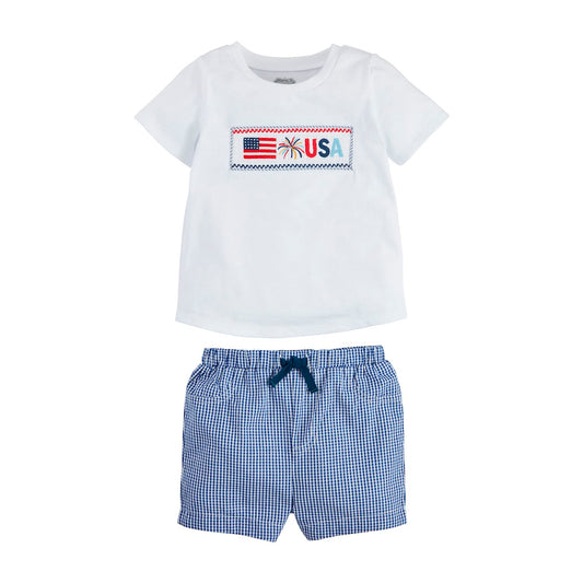 White tee with American flag smocking and "USA" text, blue/white check shorts, 100% cotton. Sizes: 2T-7.
