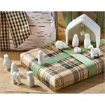 Miniature Nativity Scene featuring white figures under an open-sided porcelain structure.