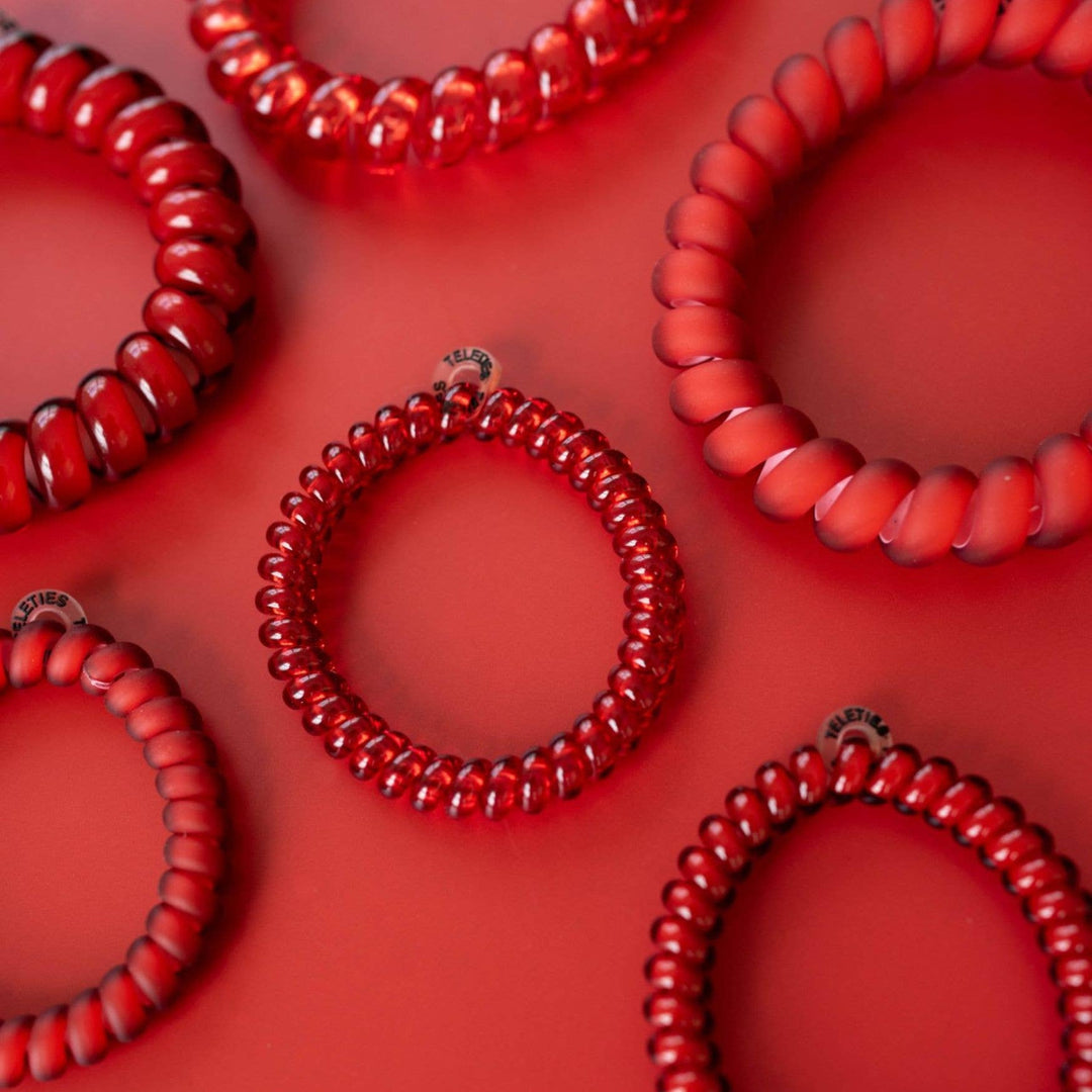 Spiral Hair Coils | Red Carpet Ready Hair Ties shown in small and large sizes. Each coil is smooth and glossy.