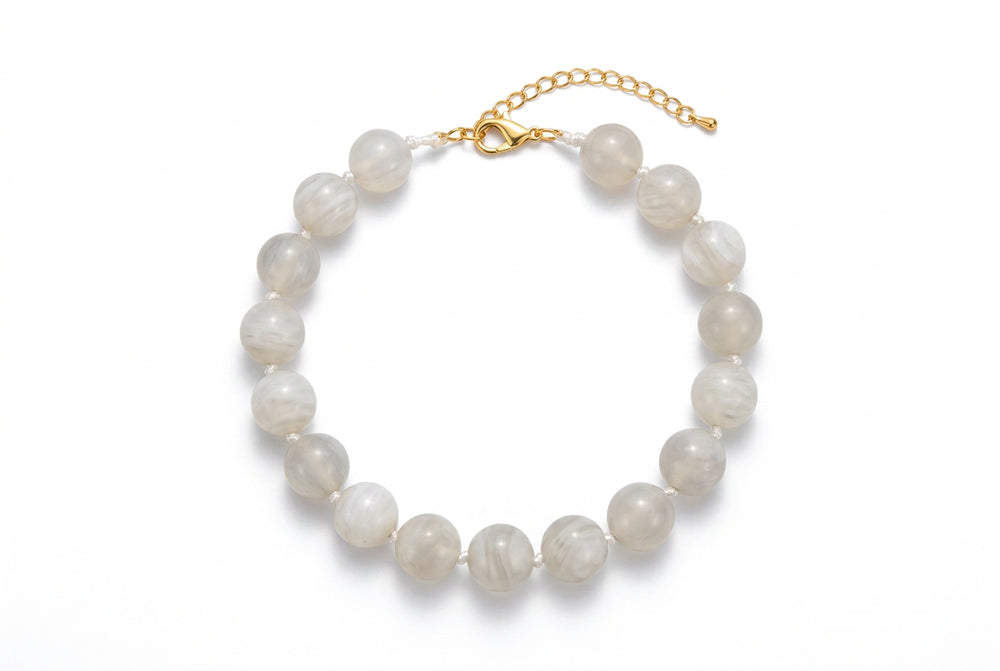 Marbled light grey beaded necklace with metal chain clasp.