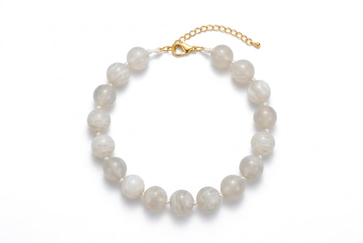 Marbled light grey beaded necklace with metal chain clasp.