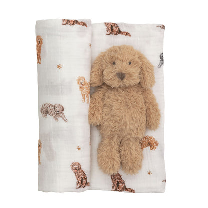 Soft brown stuffed dog atop white muslin swaddle blanket with puppy print. Swaddle size: 47"x47".