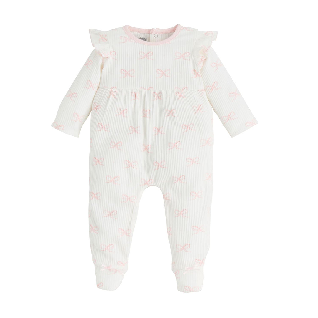 The Ruffle Bow Baby Sleeper is a white long-sleeve onesie featuring ruffled shoulders, pink bow patterns, snap buttons at the back, and a light pink-trimmed neckline. Available in sizes: Newborn, 0-3M, 3-6M, 6-9M.