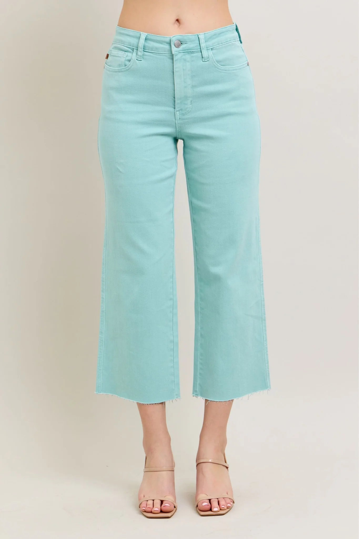 Judy Blue HW Garment Dyed Light Sky Blue Crop Wide Jeans feature frayed hems, a button and zip closure, and front pockets. Available in sizes 0 to 24W.