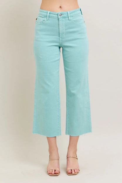 Judy Blue HW Garment Dyed Light Sky Blue Crop Wide Jeans feature frayed hems, a button and zip closure, and front pockets. Available in sizes 0 to 24W.