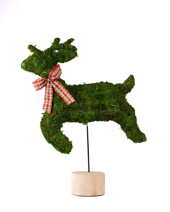 Moss-covered leaping deer figurine with a red and green plaid ribbon on a wooden base.
