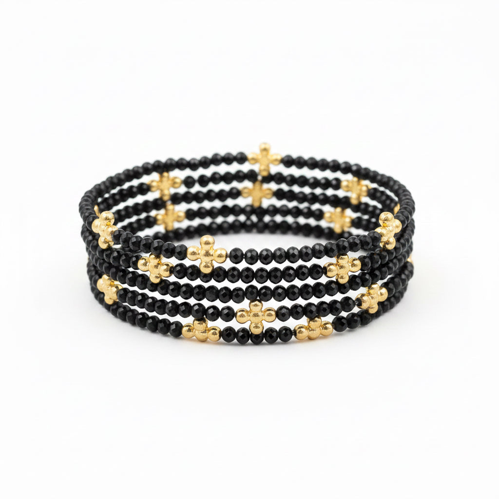 Set of 5 stretch bracelets featuring small black beads with gold cross-shaped accents. Available in standard size.