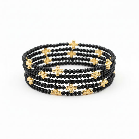 Set of 5 stretch bracelets featuring small black beads with gold cross-shaped accents. Available in standard size.