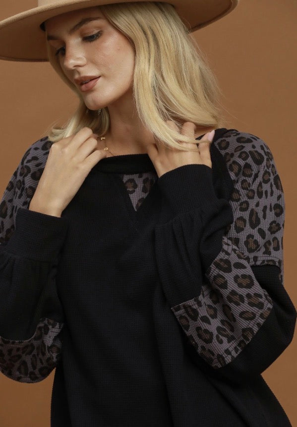 Leopard Mix Thermal Top with waffle-textured knit and bold leopard print sleeves. Available in sizes XS–XL.