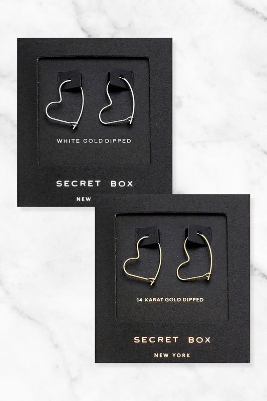 Heart-shaped hoop earrings in two styles: "White Gold Dipped" and "14K Gold Dipped." Available sizes: not specified. Packaging: Secret Box New York.