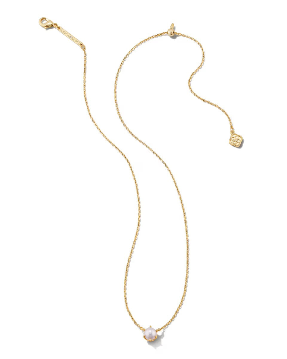 The Ashton Pearl Necklace by Kendra Scott: gold chain, single white pearl pendant, small gold tag; available in 16"–18".