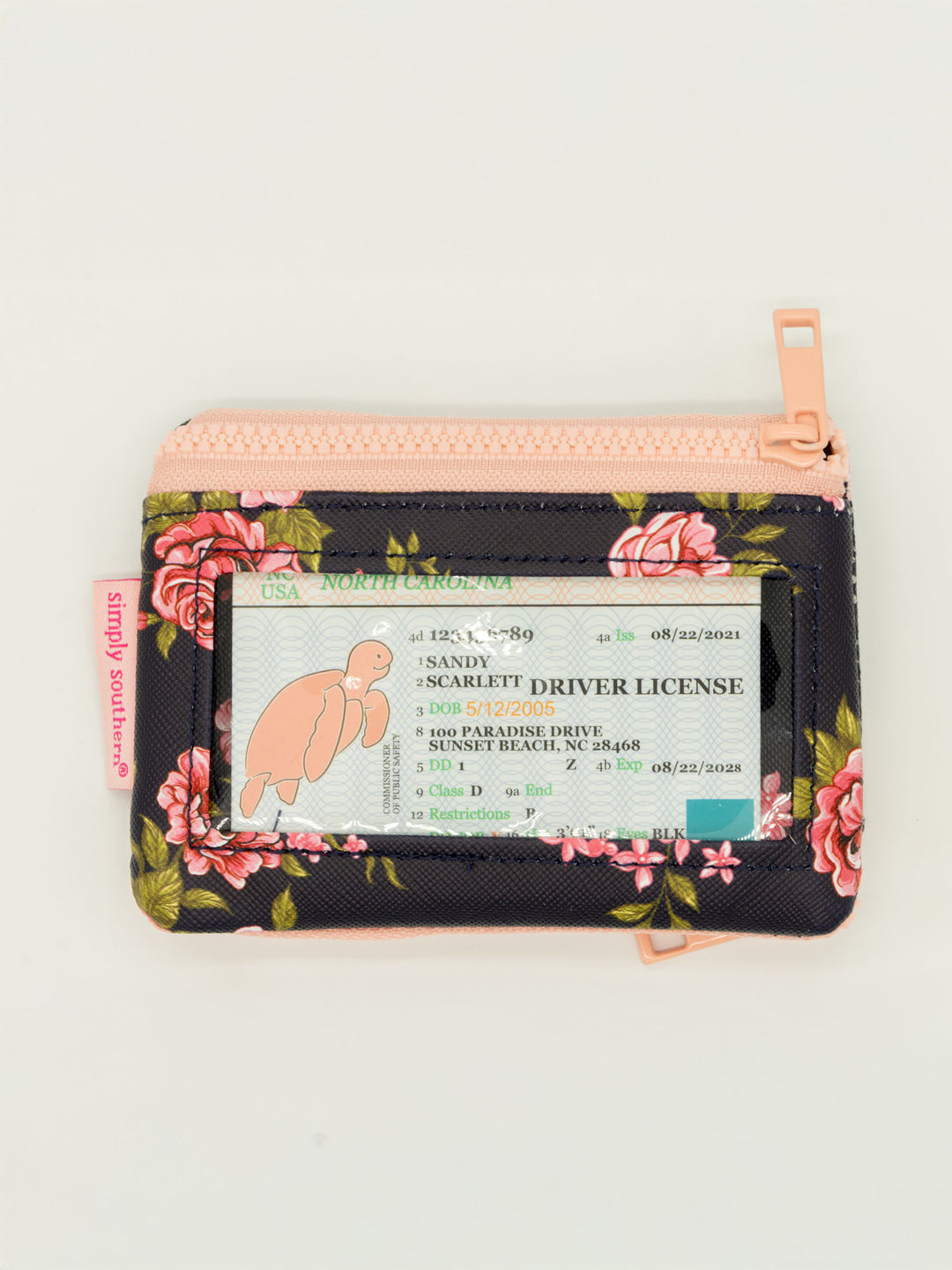 Small floral ID wallet with zip pockets, clear window, attached keyring. Size: one size.