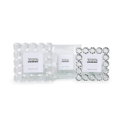 Set of three handcrafted crystal frames with faceted borders, "Tozai Home" label, available in multiple sizes.