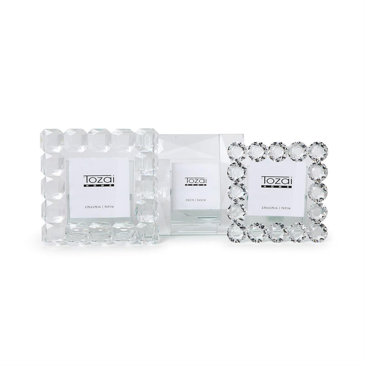 Set of three handcrafted crystal frames with faceted borders, "Tozai Home" label, available in multiple sizes.