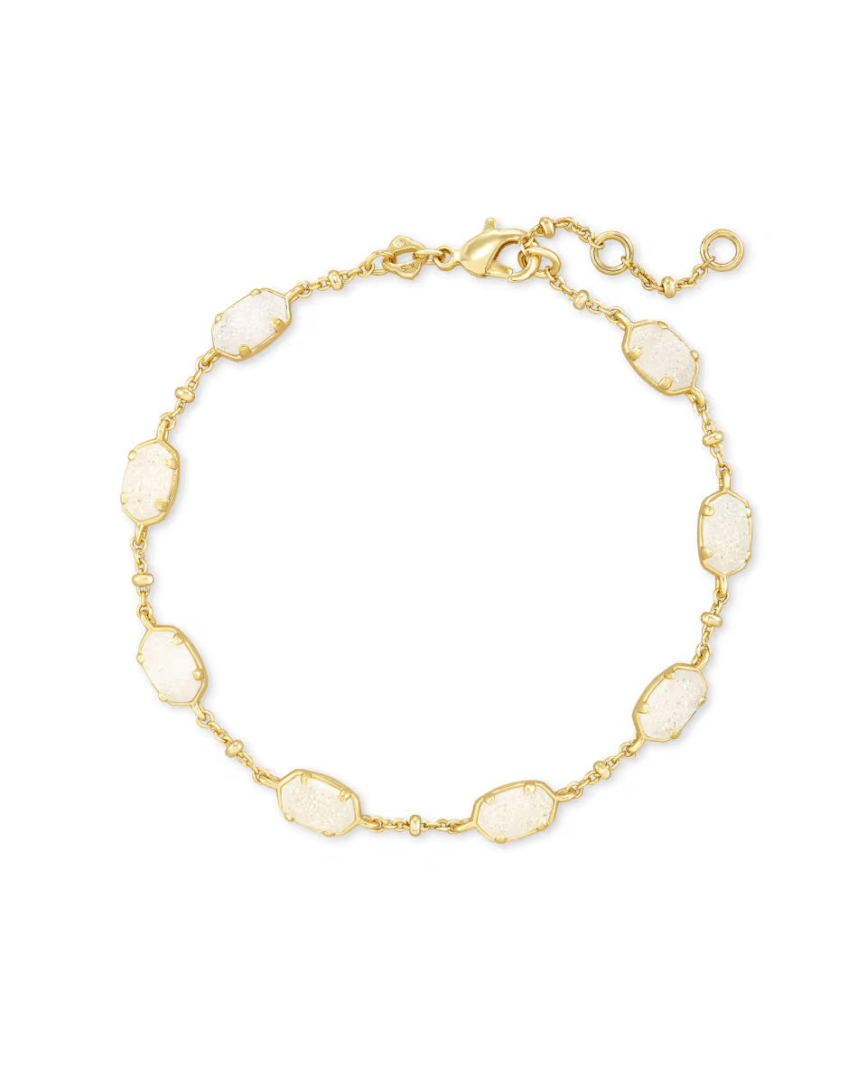 Gold chain bracelet with seven oval white stones, adjustable lobster clasp. Available in small, medium, and large sizes.