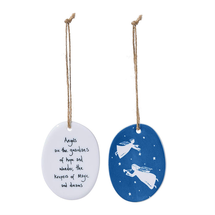 Two oval porcelain ornaments: one white with black text reading “Angels are the guardians of hope and wonder, the Keepers of Magic and dreams,” and one blue with white angel silhouettes and stars.
