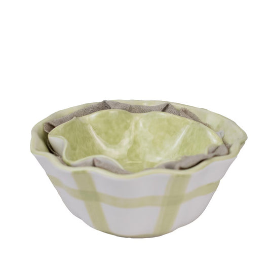 The Gingham Ruffle Nesting Bowls, Set of 2, feature ruffled edges and include a white outer bowl with green plaid and a textured light green inner bowl. Microwave and dishwasher safe. Sizes: Outer bowl - 8" diameter, Inner bowl - 6" diameter.